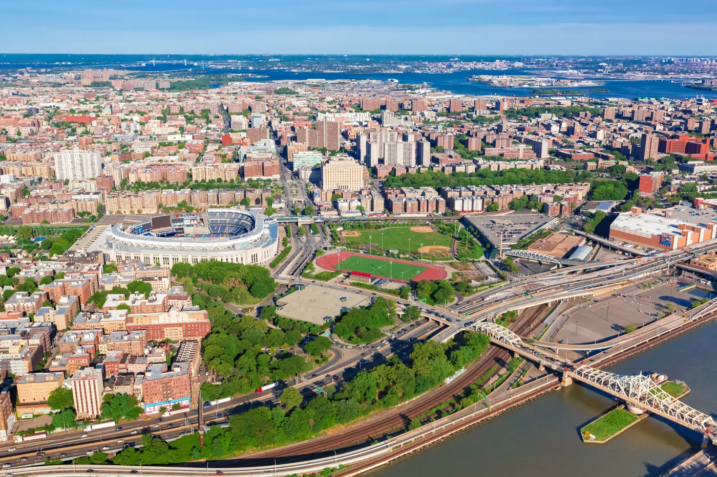 How We Became Window King | A NY Metro, Tri-State Legacy Aerial view of The Bronx, New York City, featuring Yankee Stadium, surrounding neighborhoods, highways, and the Harlem River on a bright sunny day.