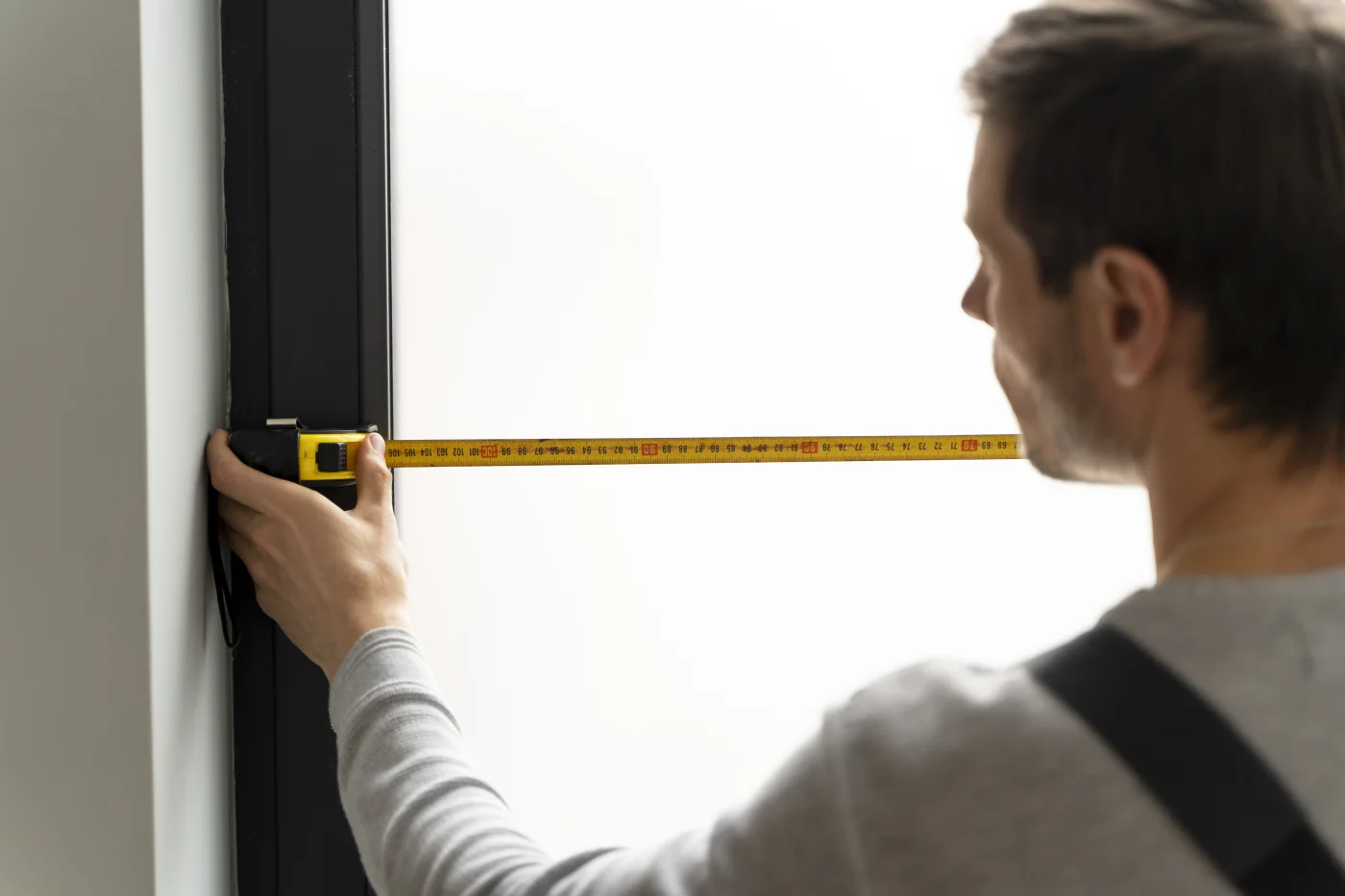 The 5% Rule – Elite Window & Entry Door Workmanship | Window King Window king installer measures new windows during replacement in the bronx