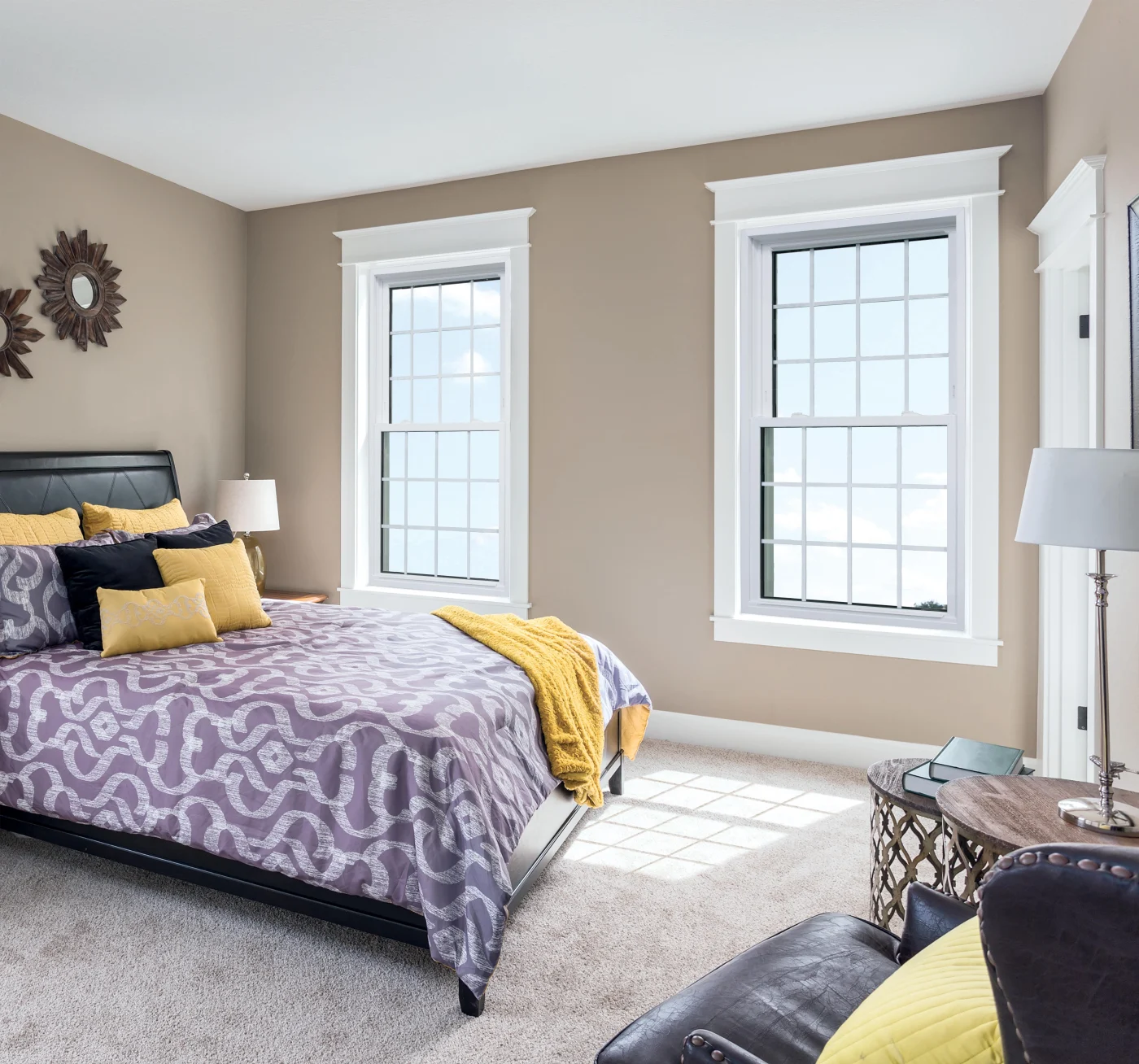 A well-lit bedroom featuring two perfectly installed double-hung windows with sharp, clean trim. The crisp white framing and symmetrical placement showcase the kind of quality that only comes with experienced oversight and precise workmanship. Every corner, edge, and line looks intentional—reflecting Window King’s standard of excellence and project management from start to finish.