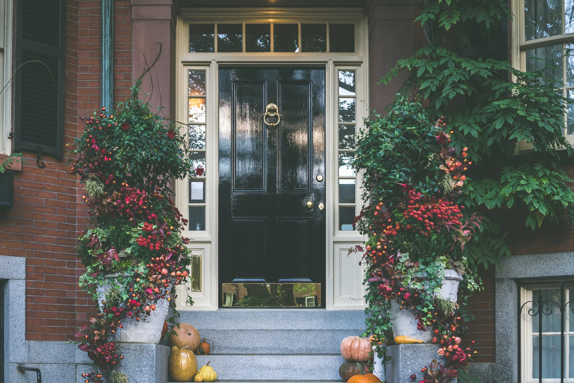A home with a newly installed entry door with sidelights and a transom.