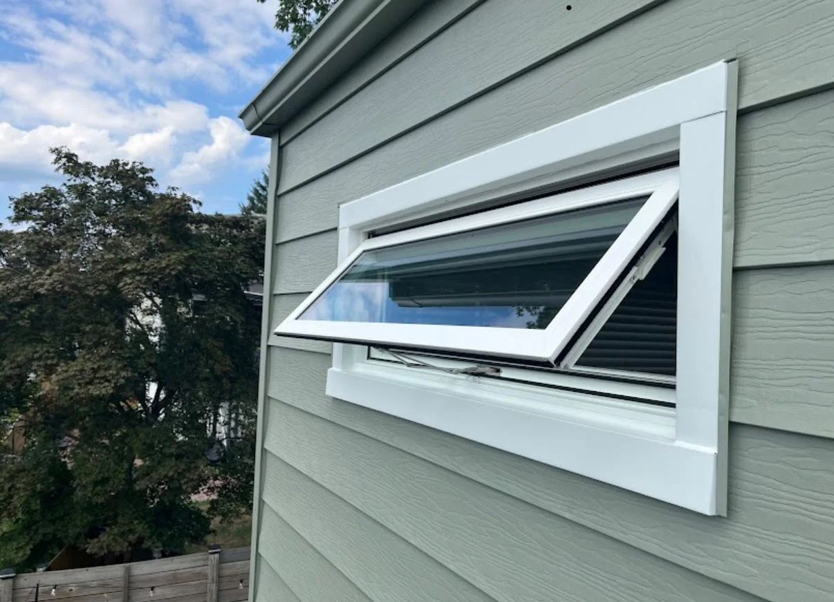 Incredible Window Replacement Brooklyn Ny Window King An awning-style replacement window opened outward on a home exterior, showcasing energy-efficient window design and clean white trim.