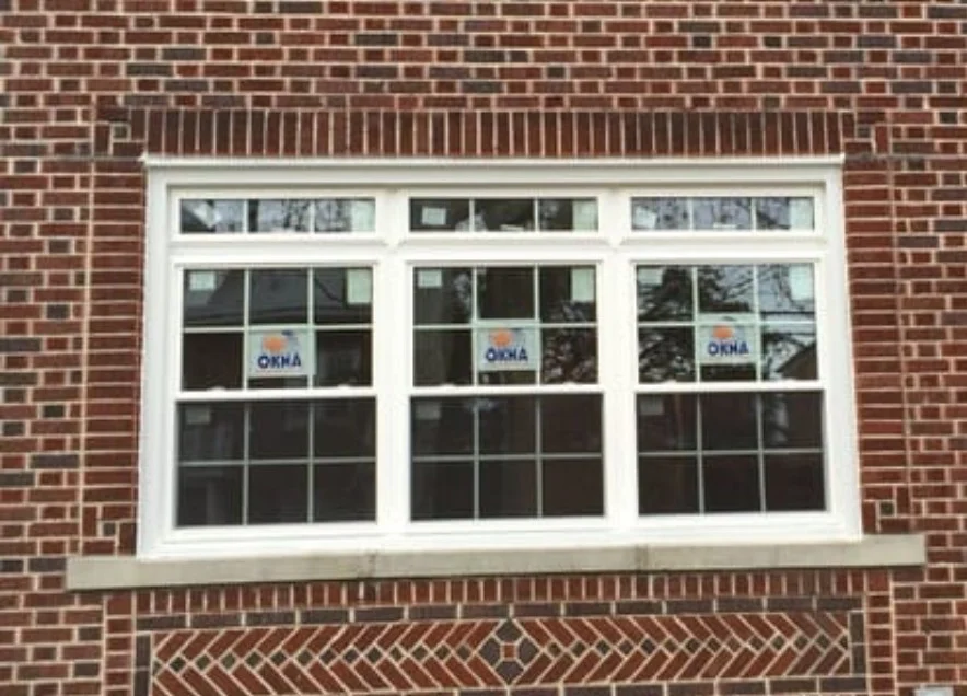 Superior Window Installation Bronx Ny Window King White OKNA replacement windows installed in a red brick exterior wall, with grid-style panes, white trim, and exterior brick detailing