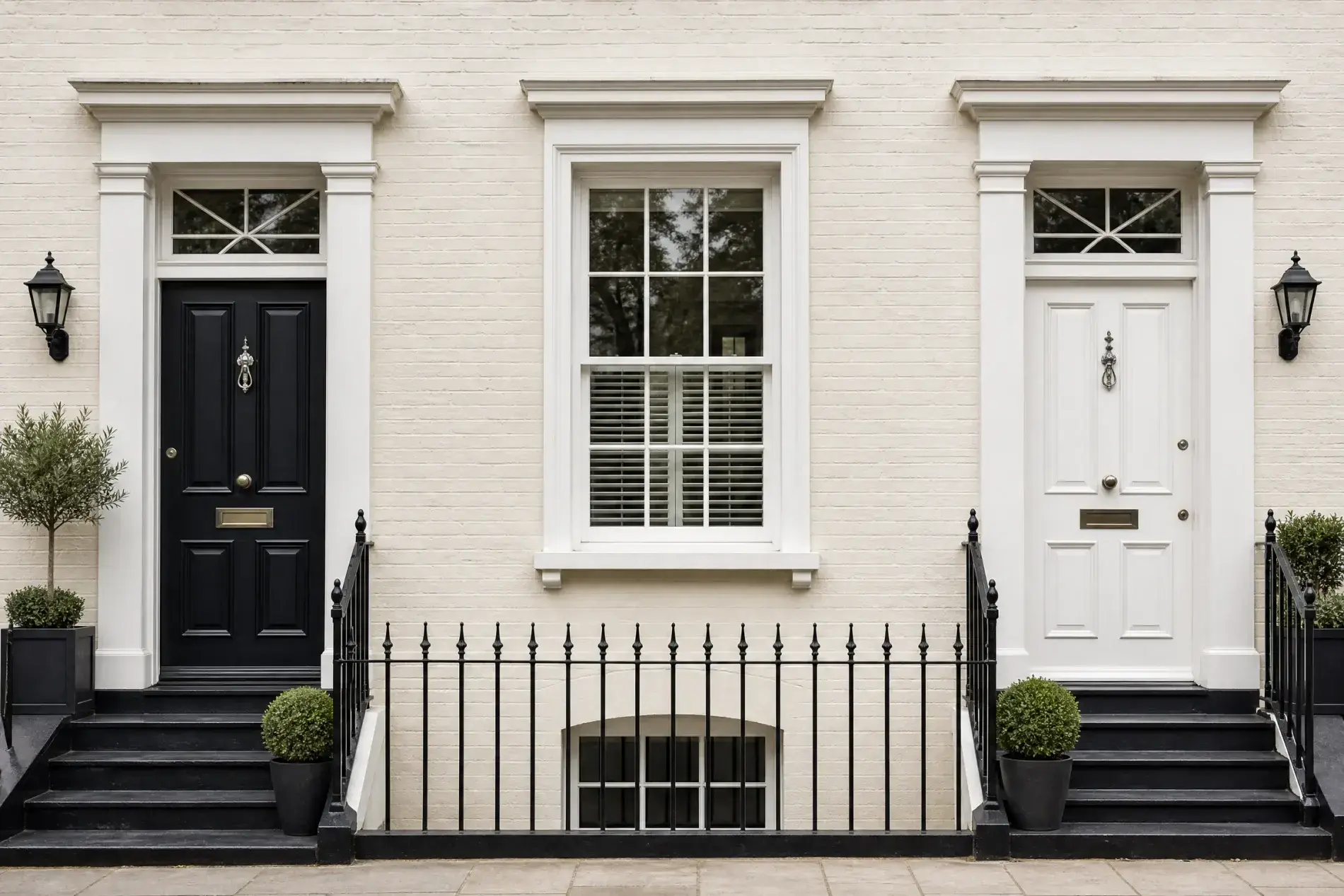 Reliable Door Sales In New Rochelle, NY | Window King Black and white front doors flank a central sash window on a pale brick townhouse with black iron railings and steps.